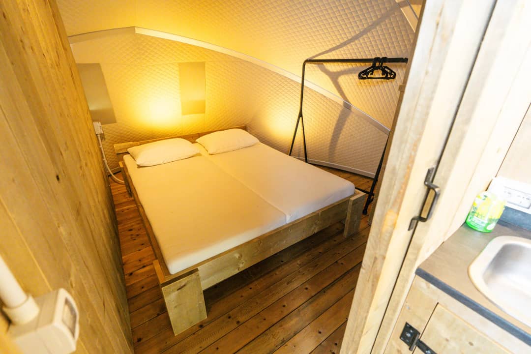 Bedroom with a double bed and wooden walls