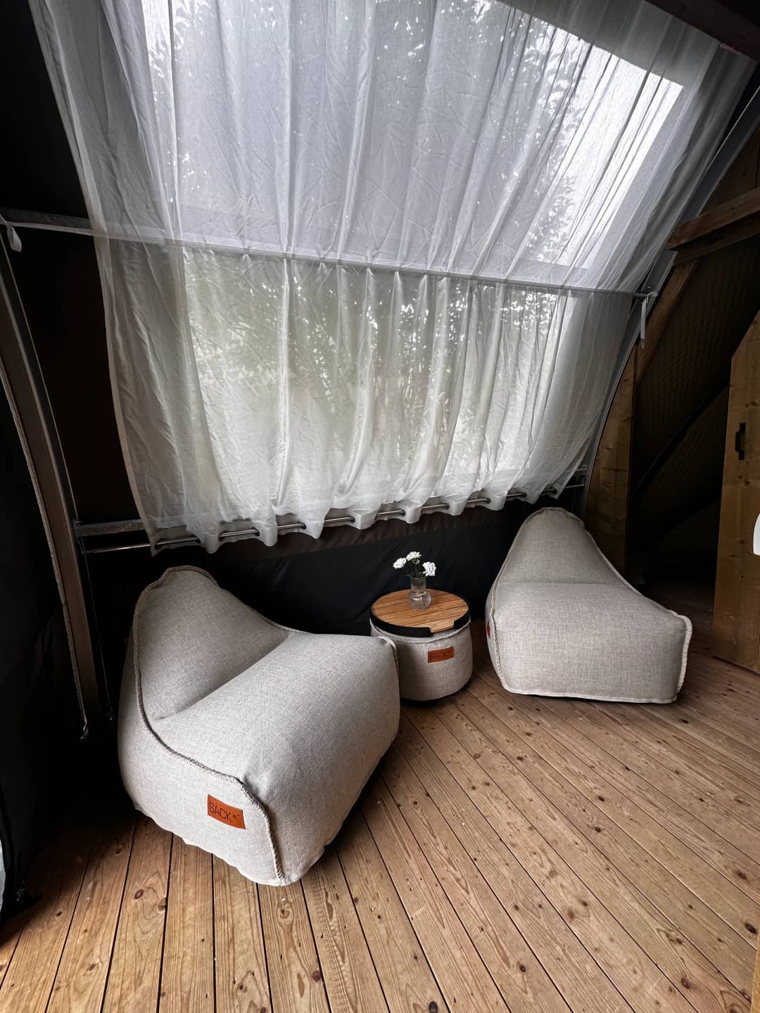 A light-coloured seating area with a side table in the Big Oak Lodge XS