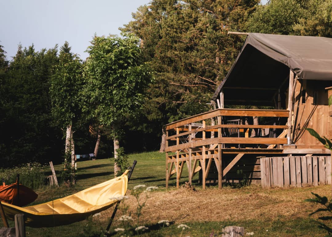 Base Lodge with a wooden terrace and a hammock amongst the trees