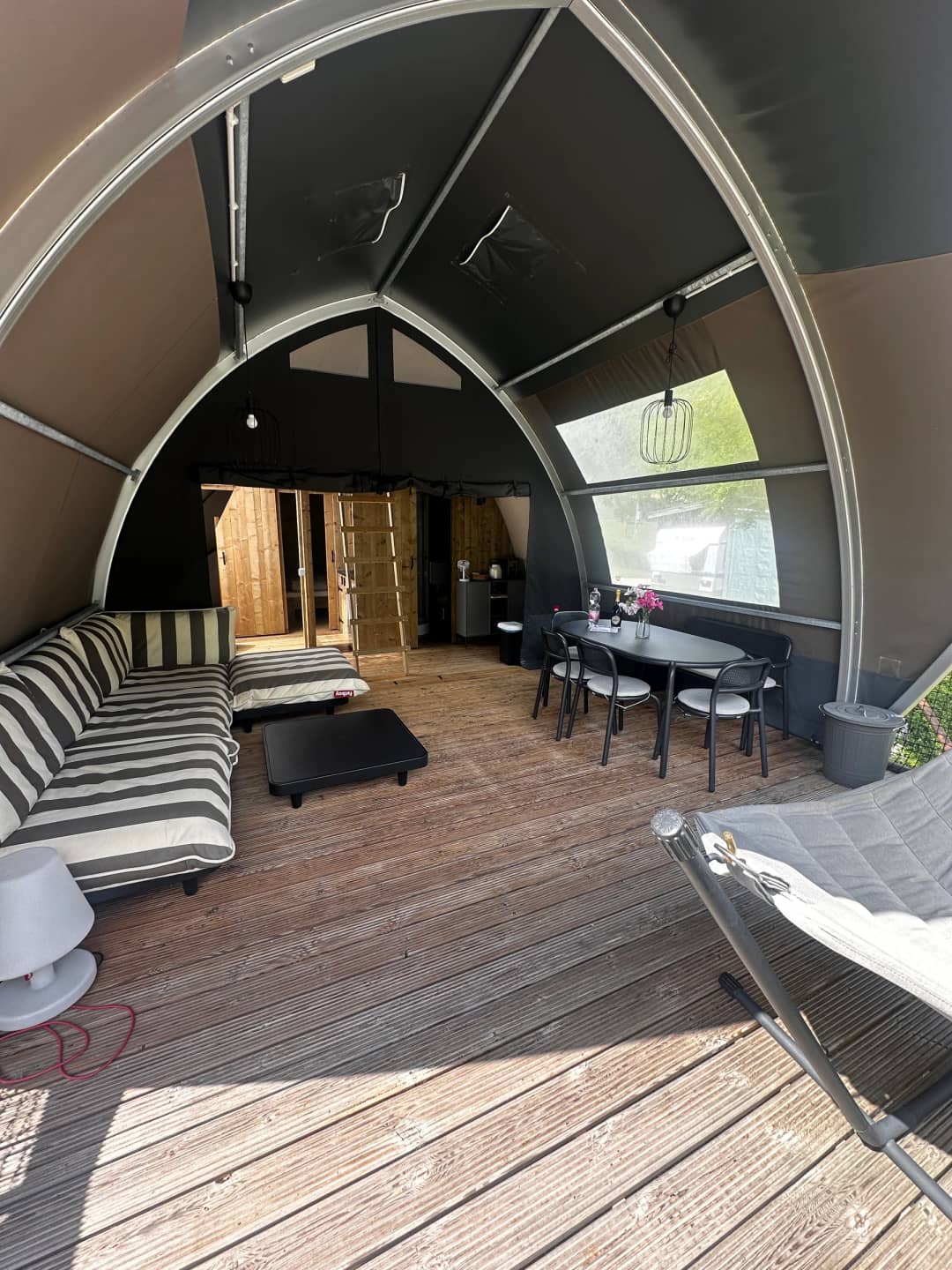 Spacious living room with a large round arch and windows