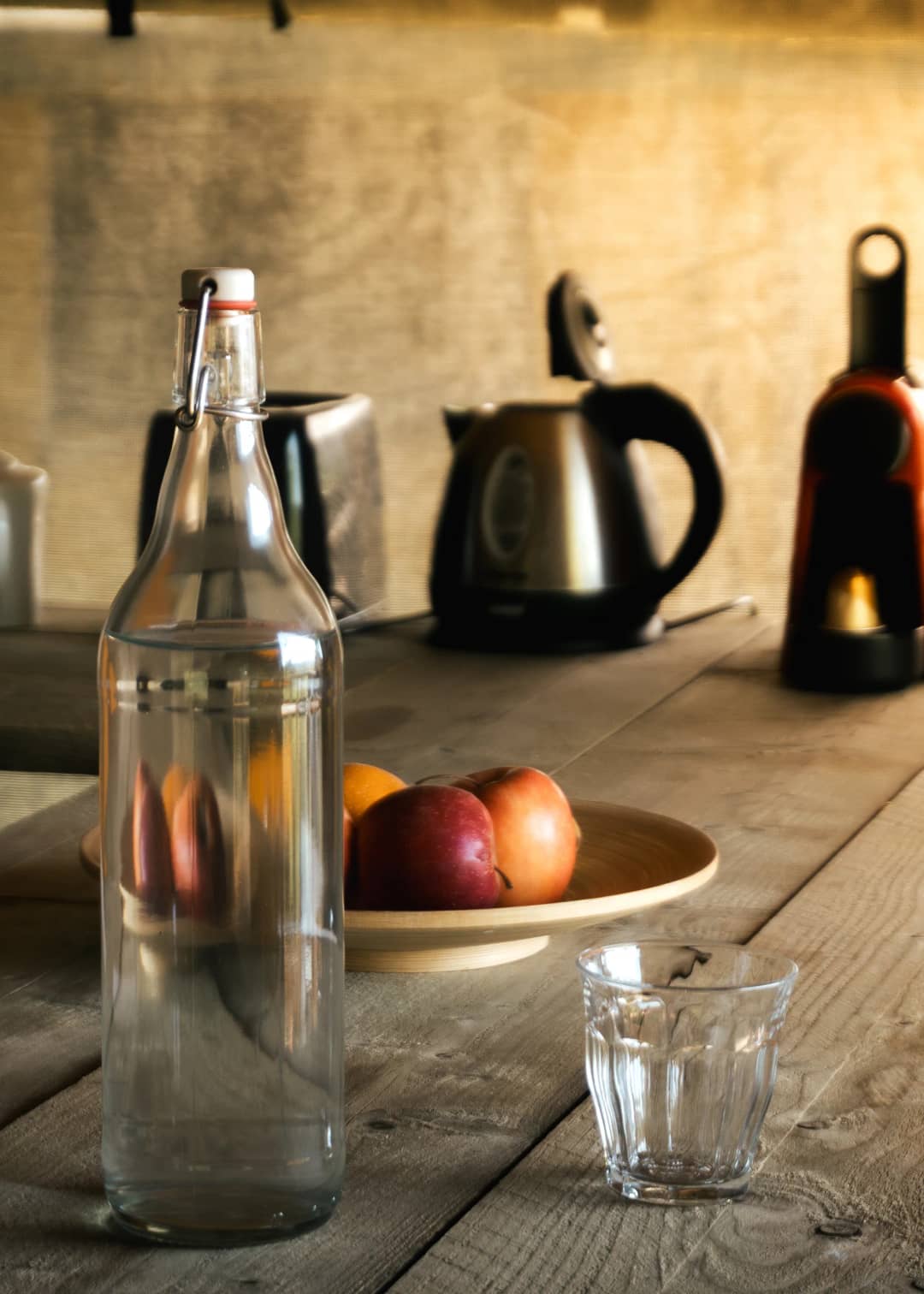 Table with a water carafe, fruit and a kettle