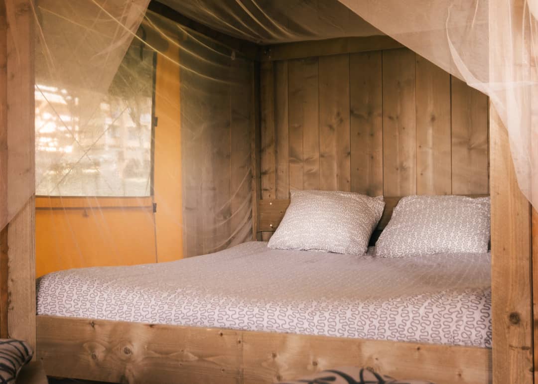 Double bed in the Base Lodge with a wooden wall