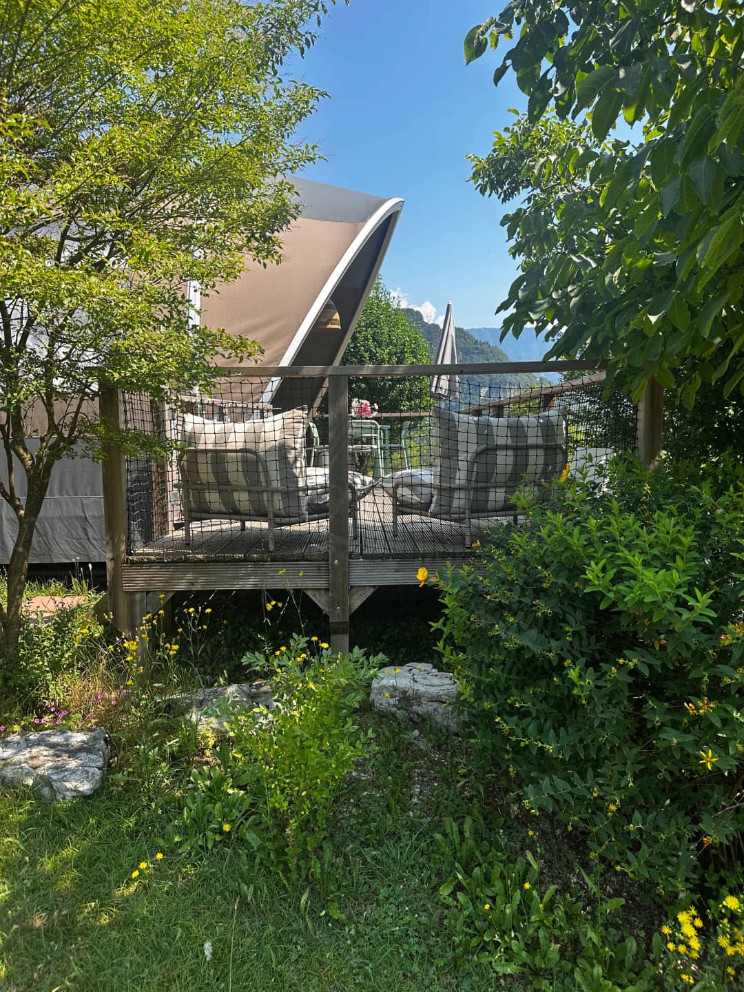 Big Oak Lodge XS on a wooden deck surrounded by greenery